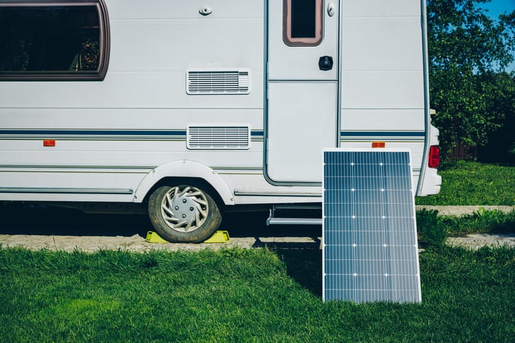 white-rv-caravan-camper-on-a-campsite-with-solar-panel